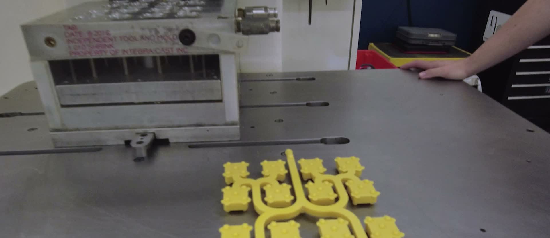 Wax pattern trees laid out on a work table at MPI
