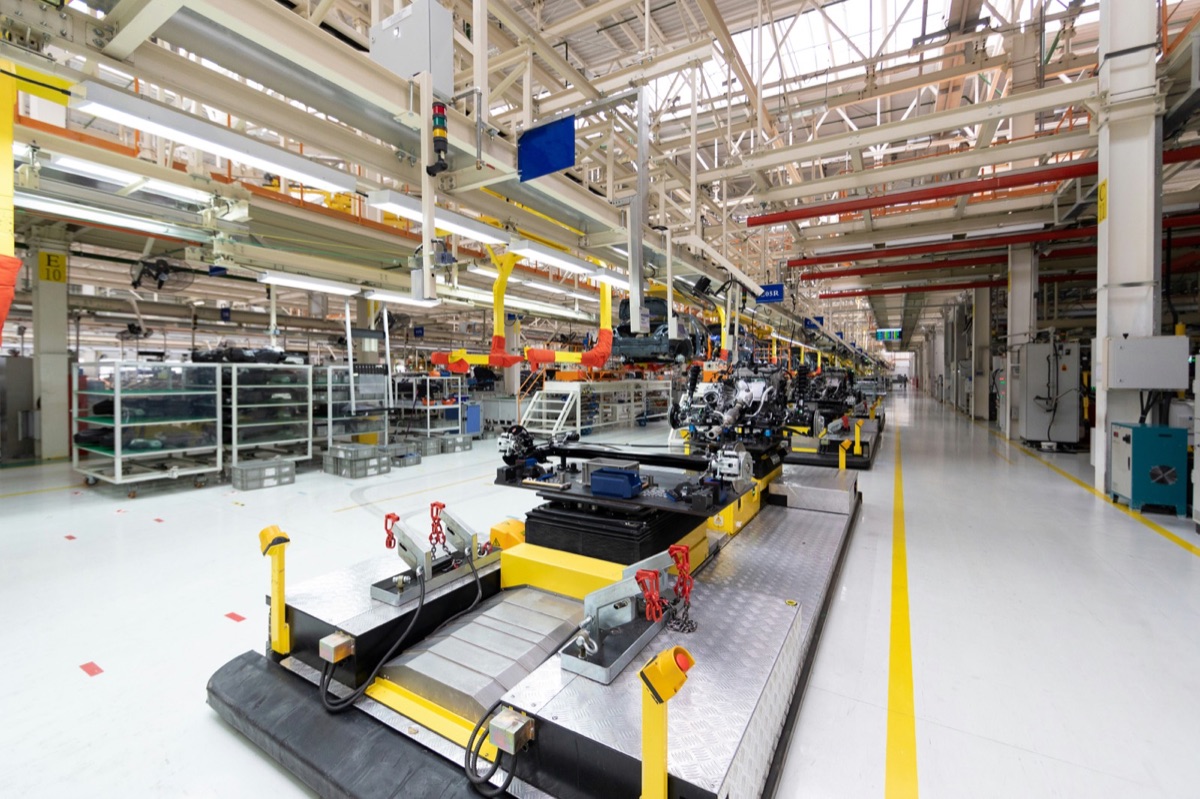 A sweeping view down a bright assembly line, the whole floor made visible at a glance